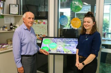 Vic volunteer phil percival and touch screen programmer georgia gleeson next to new touch screen